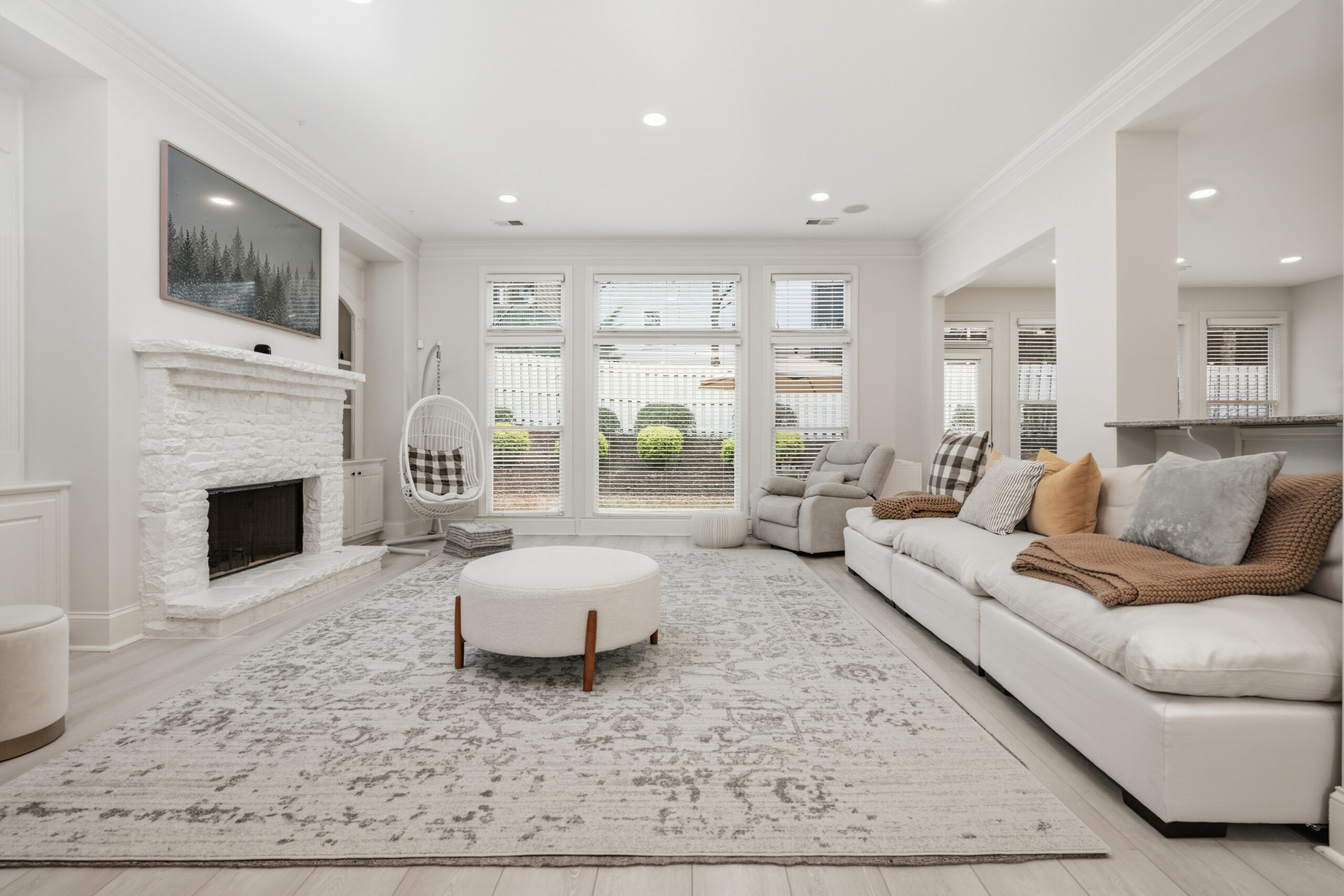 Bright living room with fireplace and built in shelving